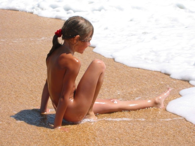 New view on family rest of nudists on the sea